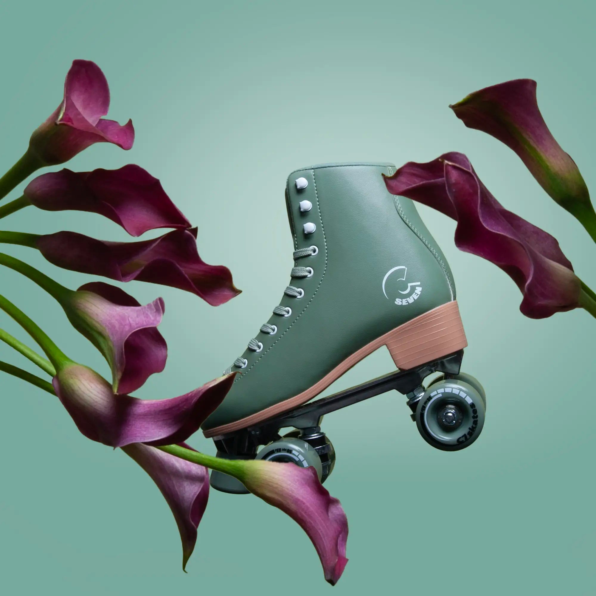 Green roller skate with pink accents featuring the brand 'C7Skates' surrounded by purple flowers on a light green background