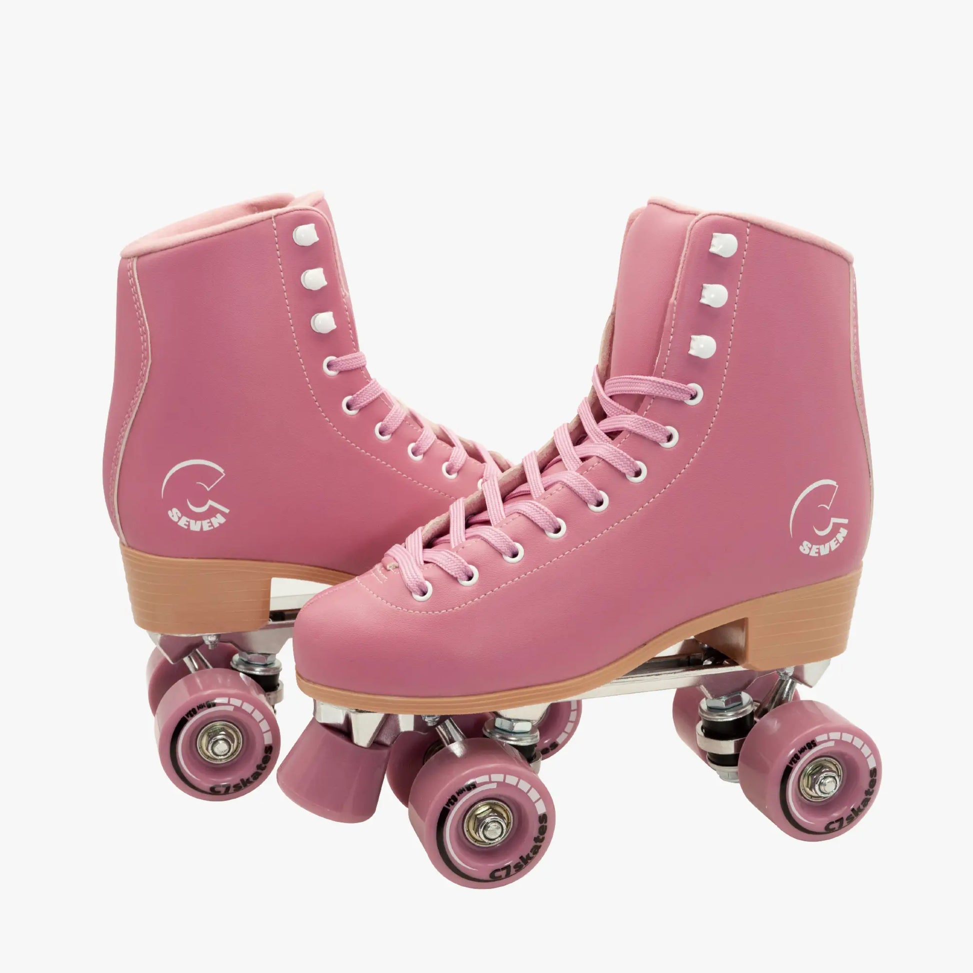 Pink roller skates with brown soles and pink wheels on a white background