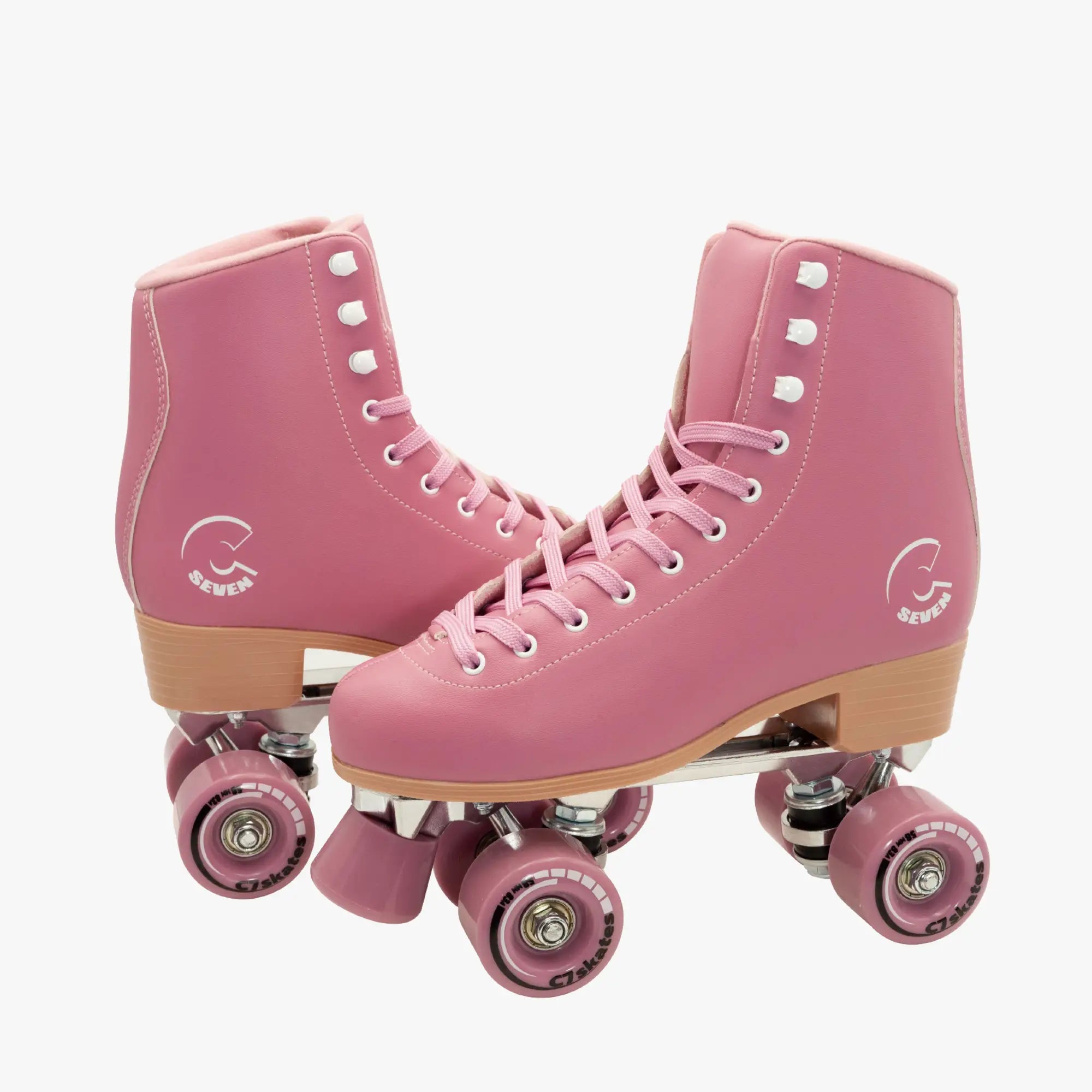 Pink roller skates with brown soles and pink wheels on a white background