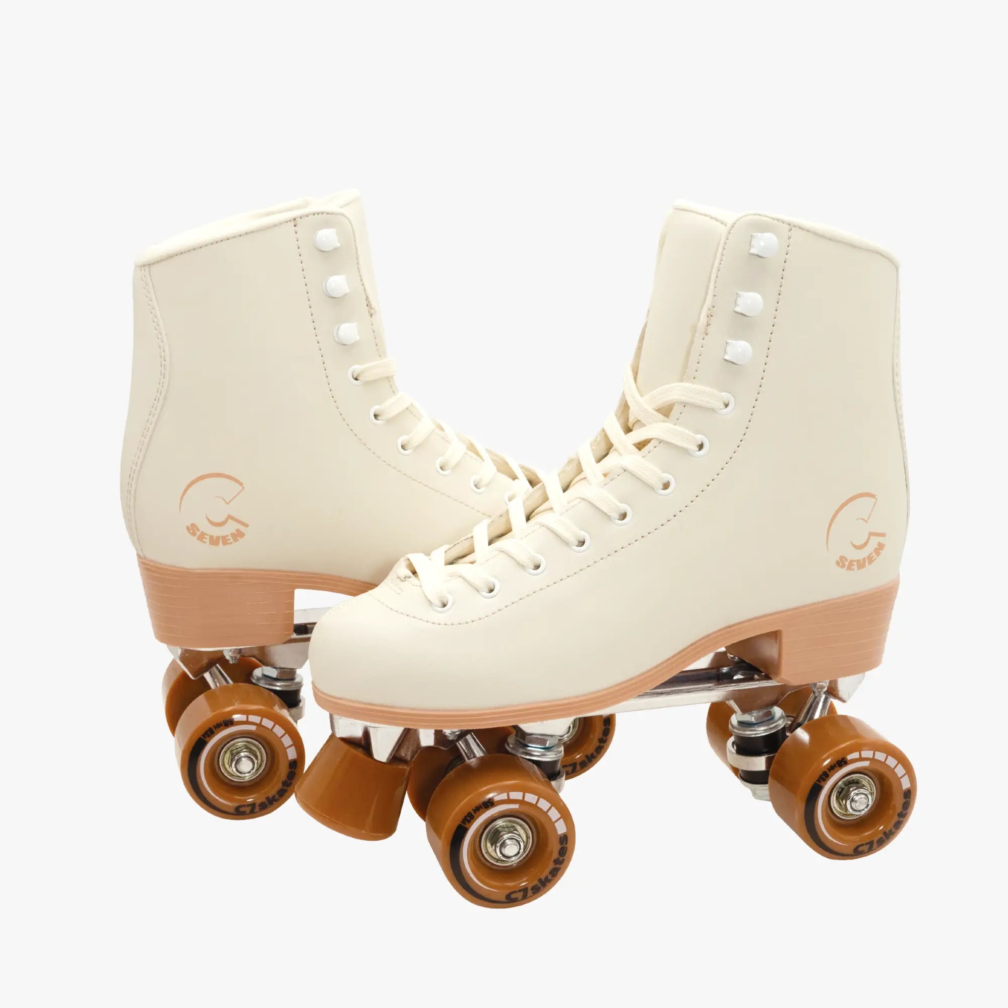 Pair of cream-colored roller skates with brown wheels on a white background
