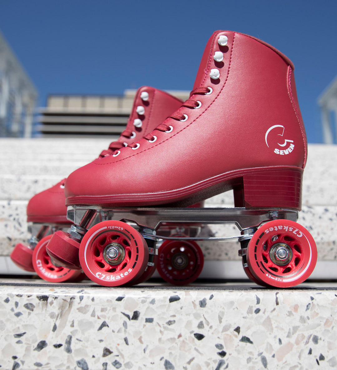 Cherrypop Quad Skates are dark red monochrome roller skates with removable toe stops, 62mm 83A wheels and a structured boot. 